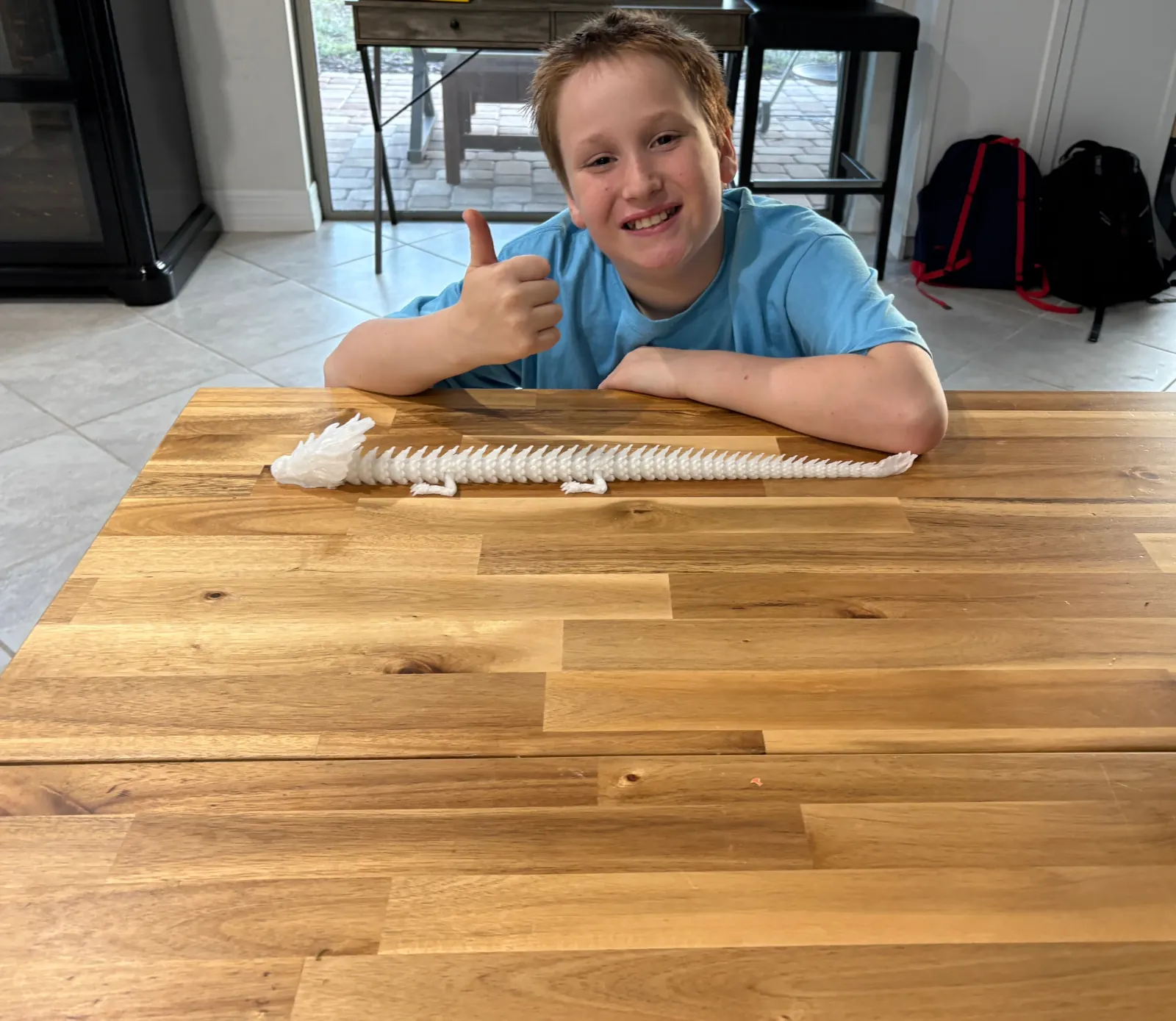 Young maker with a finished dragon print