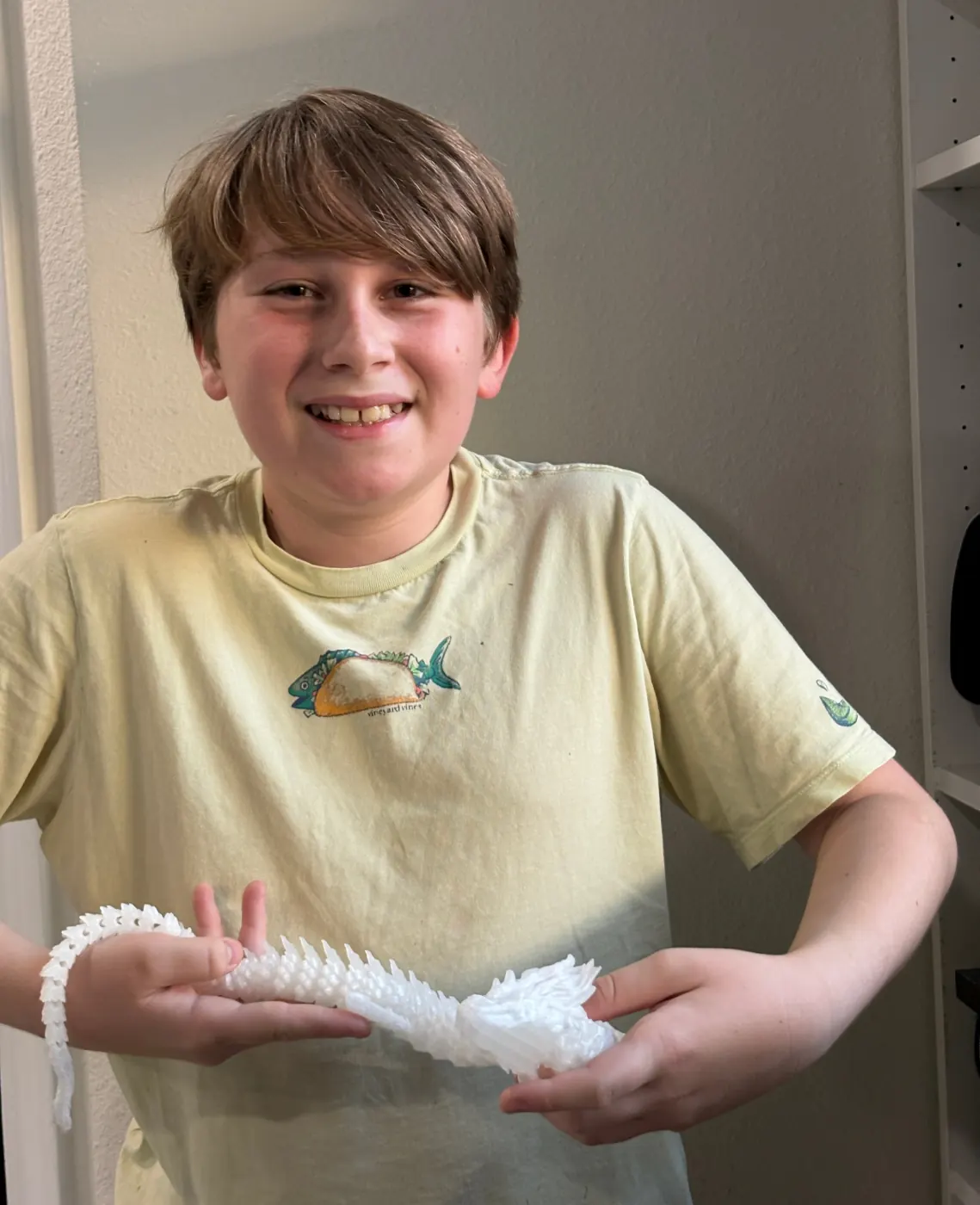 Maker holding the dragon print for a presentation photo